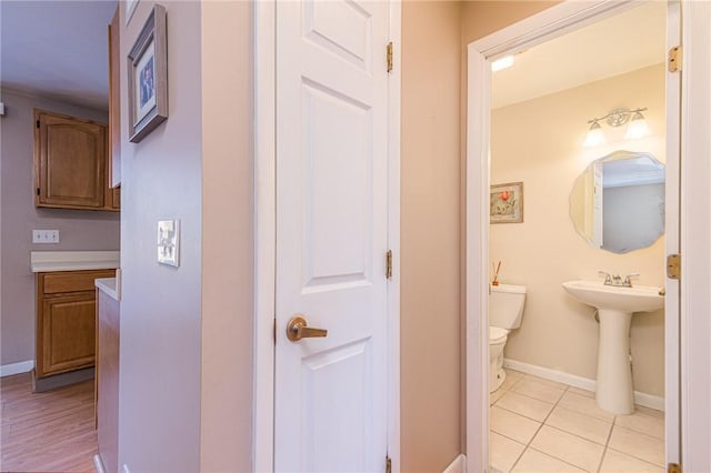 bathroom with tile patterned floors, toilet, and sink