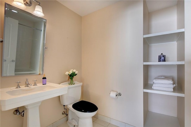 bathroom featuring toilet and tile patterned flooring