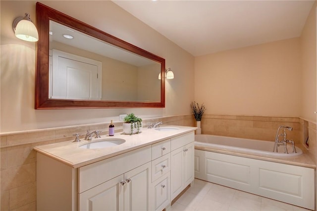 bathroom featuring vanity, a tub, and tile walls