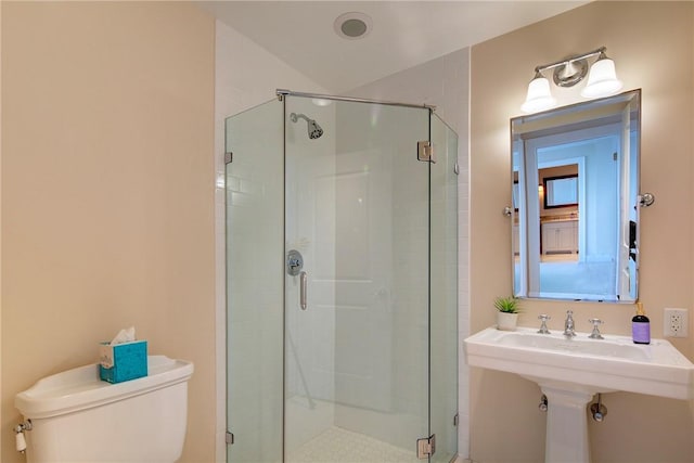 bathroom featuring walk in shower and toilet