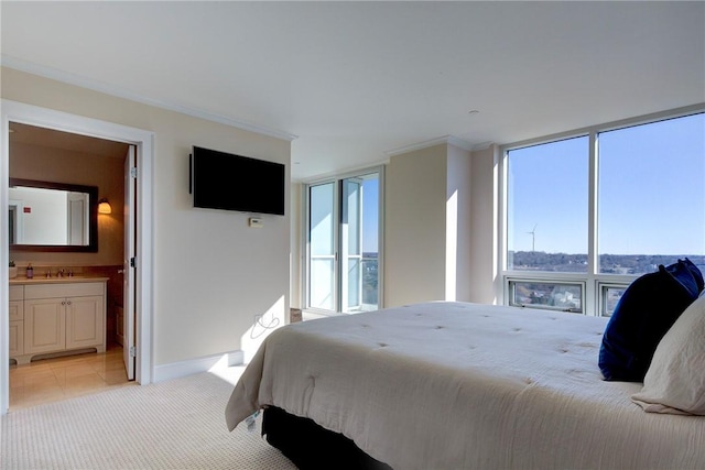 bedroom with light carpet, multiple windows, and a wall of windows