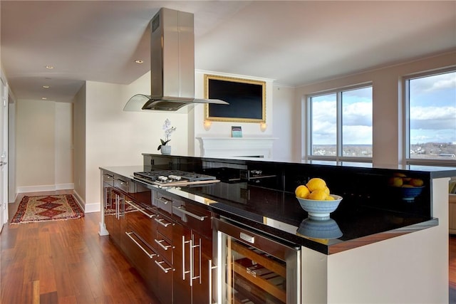 kitchen featuring wine cooler, island range hood, and dark wood-type flooring