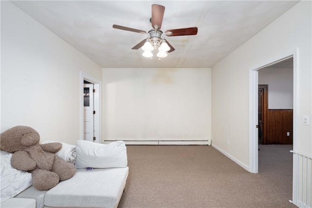 sitting room with carpet, a baseboard heating unit, and ceiling fan