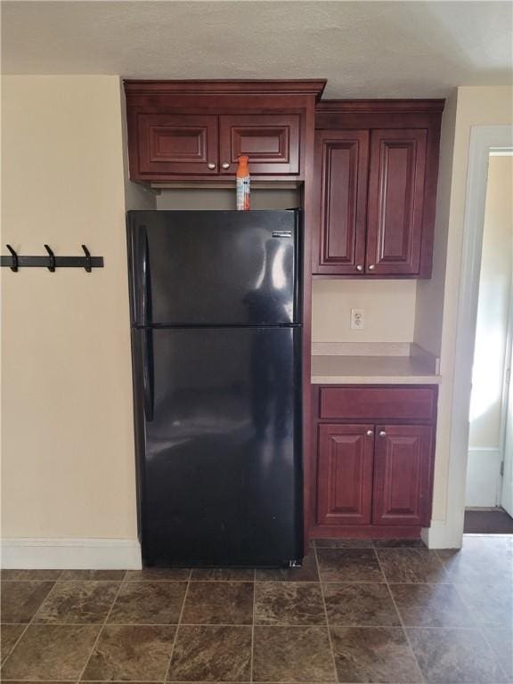 kitchen featuring black refrigerator