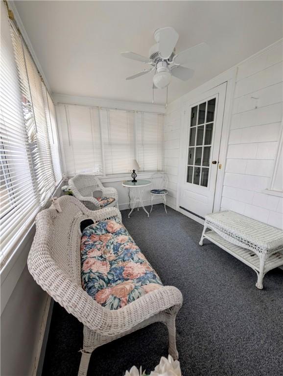 sunroom featuring ceiling fan