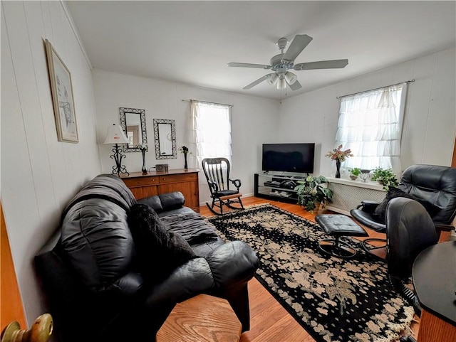 living room with ceiling fan and wood-type flooring