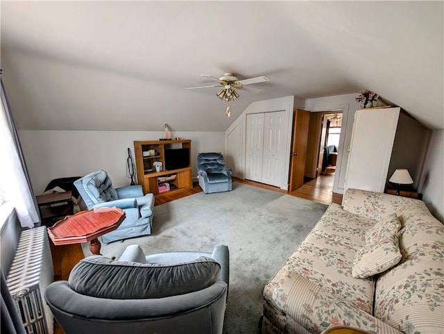 living room featuring ceiling fan and vaulted ceiling