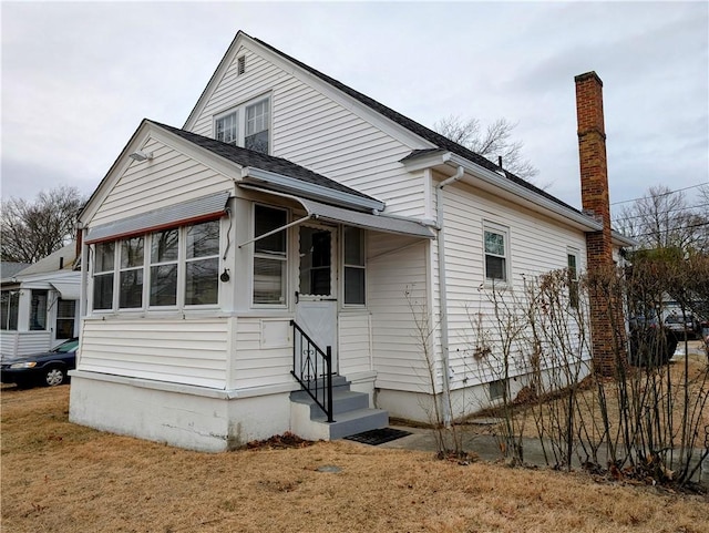 rear view of house with a lawn