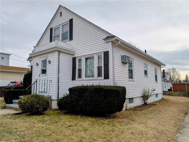 view of side of home with a yard