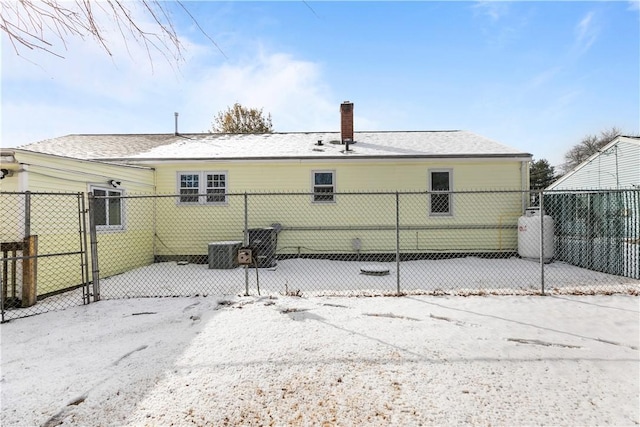 rear view of property with central AC