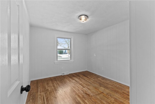 empty room with light hardwood / wood-style floors