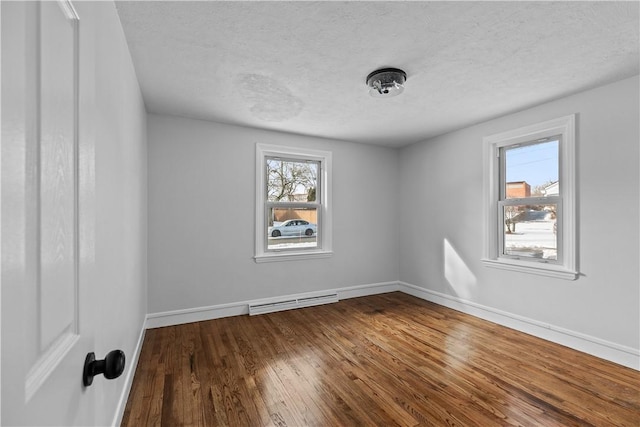 unfurnished room featuring hardwood / wood-style floors and a textured ceiling