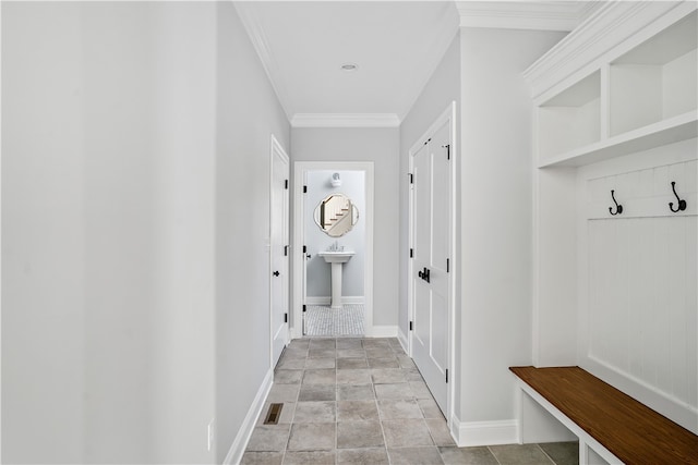 mudroom with crown molding and sink