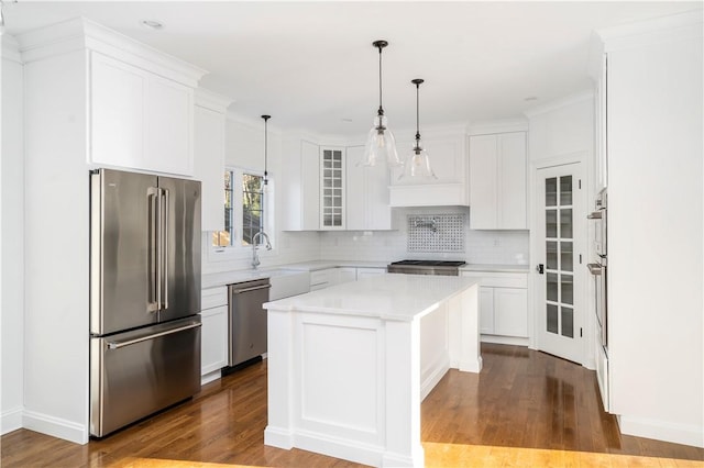 kitchen featuring a kitchen island, white cabinetry, and appliances with stainless steel finishes