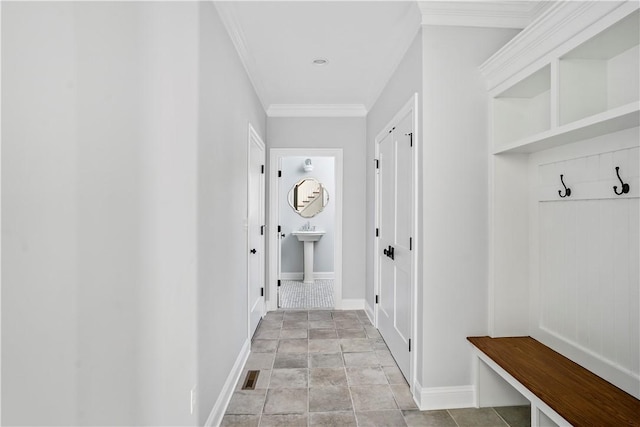 mudroom with ornamental molding and sink