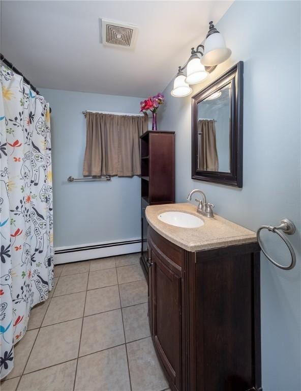 bathroom with vanity, tile patterned floors, and baseboard heating