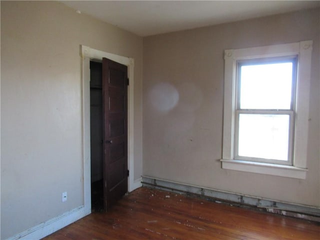 spare room featuring dark wood-type flooring