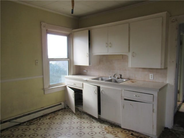 kitchen featuring white cabinetry, sink, backsplash, baseboard heating, and crown molding