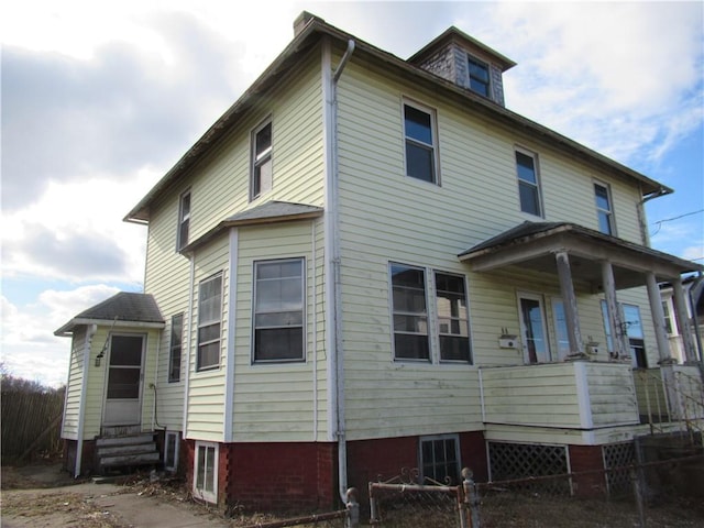 rear view of house featuring a porch