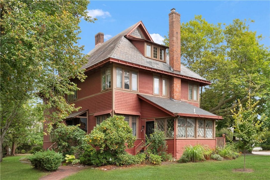 view of front of property with a front lawn and a sunroom