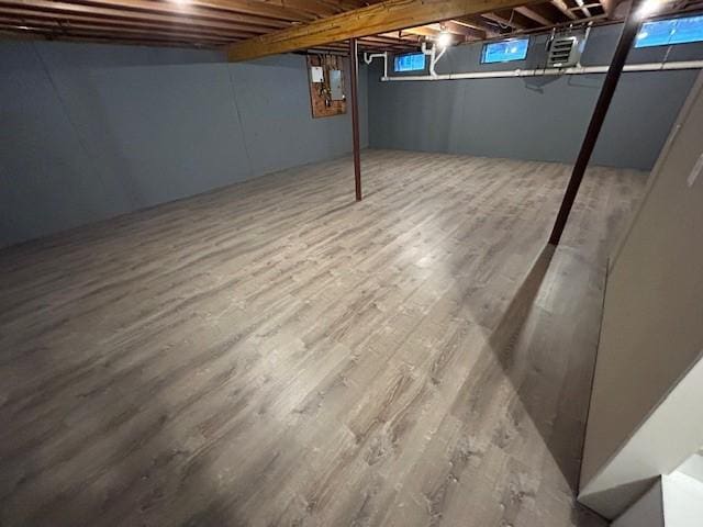 basement with hardwood / wood-style flooring