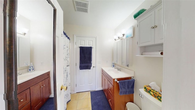 bathroom with vanity, tile patterned floors, and toilet