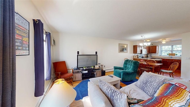 living room with a notable chandelier, light hardwood / wood-style flooring, and a baseboard heating unit