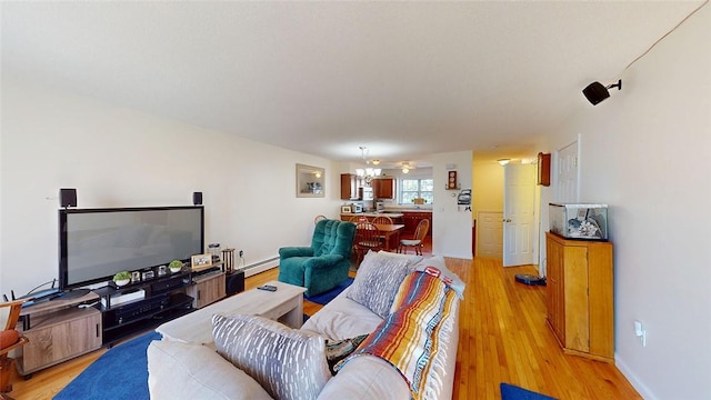 living room with light hardwood / wood-style flooring and a baseboard radiator