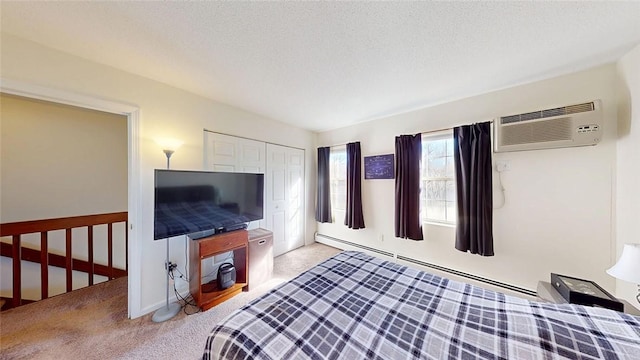 bedroom featuring light colored carpet, an AC wall unit, a textured ceiling, and baseboard heating