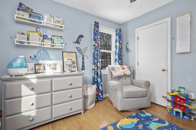 game room with light hardwood / wood-style flooring