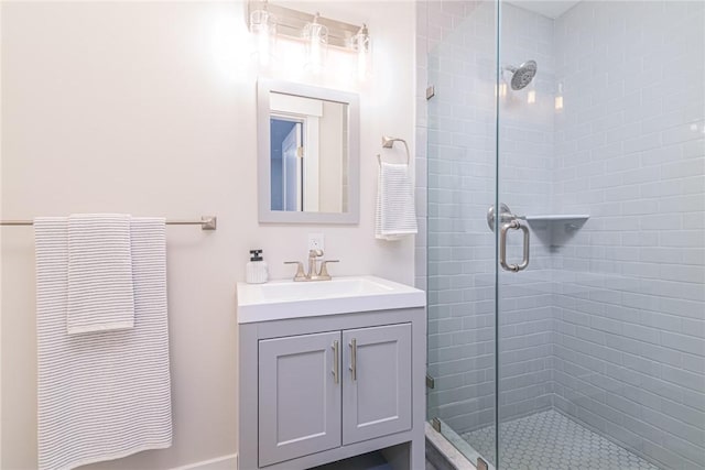 bathroom featuring walk in shower and vanity