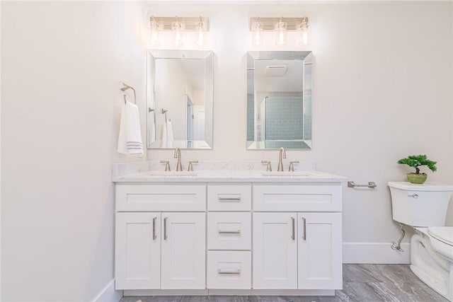 bathroom featuring vanity, toilet, and a shower with door