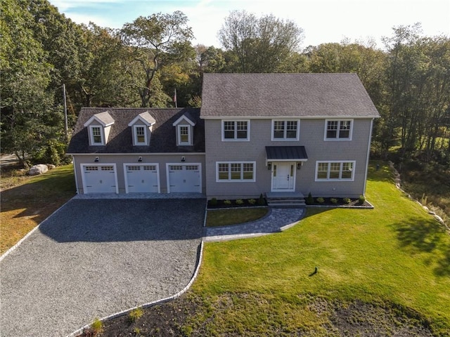 view of front of home with a garage and a front lawn