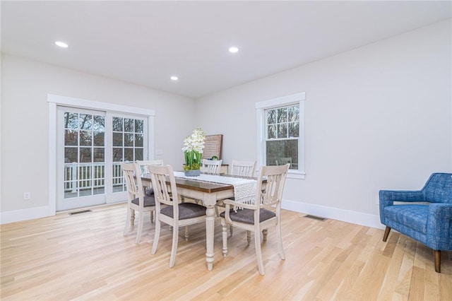 dining space with light hardwood / wood-style floors