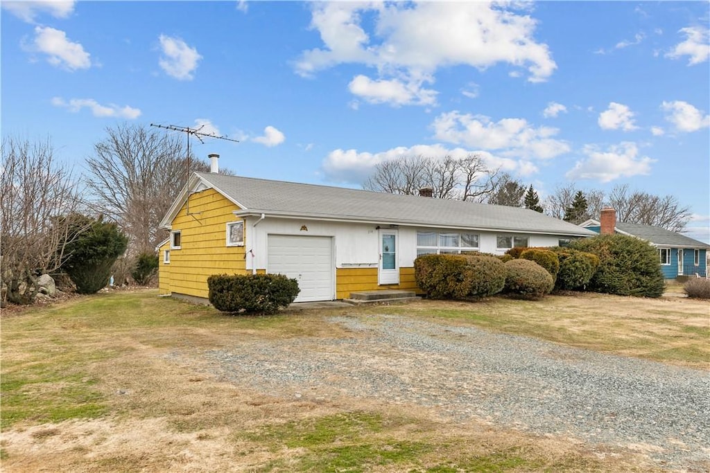 single story home with a garage and a front yard