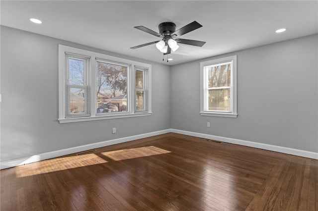 unfurnished room with ceiling fan, wood-type flooring, and a healthy amount of sunlight