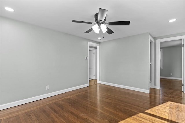 spare room featuring dark hardwood / wood-style flooring and ceiling fan