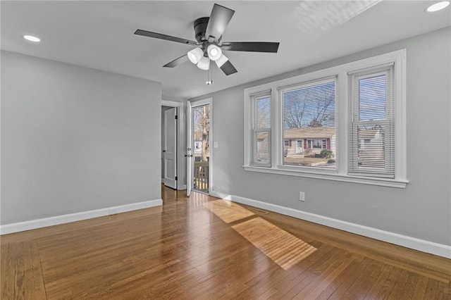 empty room featuring wood-type flooring and ceiling fan