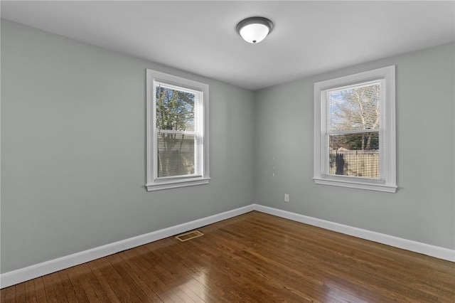 unfurnished room with hardwood / wood-style floors