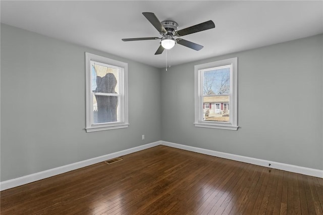 unfurnished room featuring dark wood-type flooring and ceiling fan