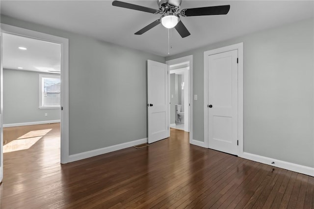 unfurnished bedroom with dark hardwood / wood-style floors, ceiling fan, and a closet