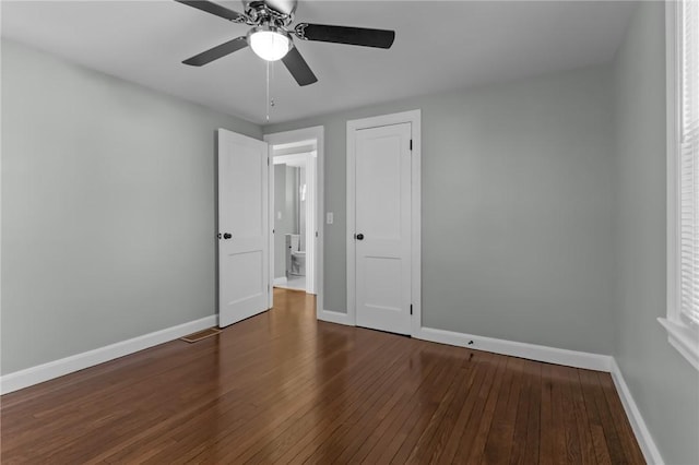 unfurnished bedroom with ceiling fan and dark hardwood / wood-style floors