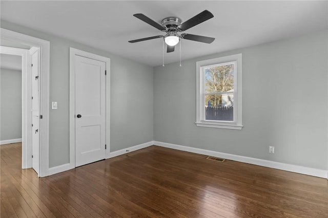 unfurnished bedroom featuring dark hardwood / wood-style floors and ceiling fan