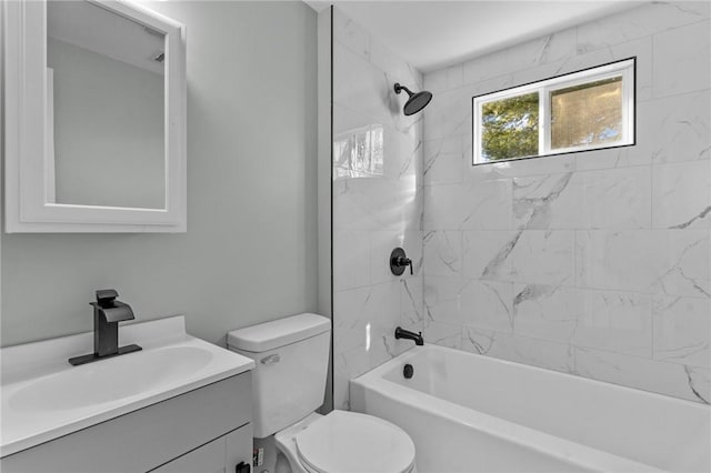 full bathroom featuring vanity, toilet, and tiled shower / bath