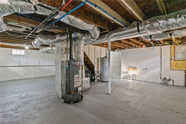 basement featuring electric panel and water heater