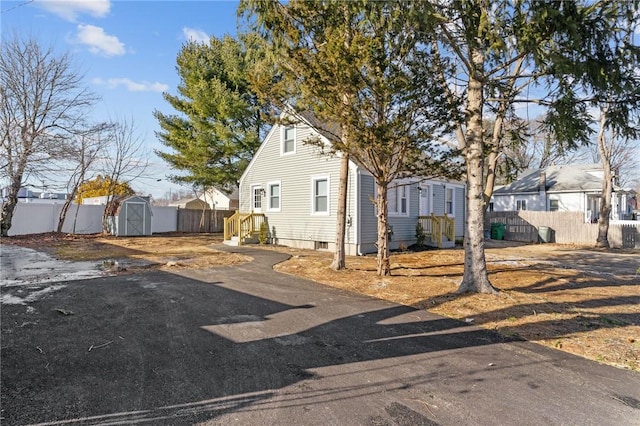 view of front of property with a storage shed