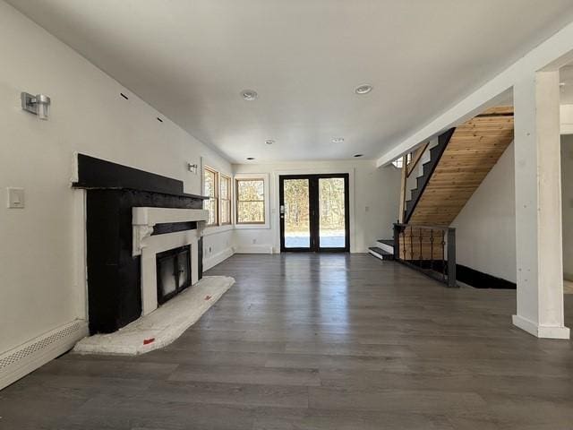 unfurnished living room with french doors and dark hardwood / wood-style floors