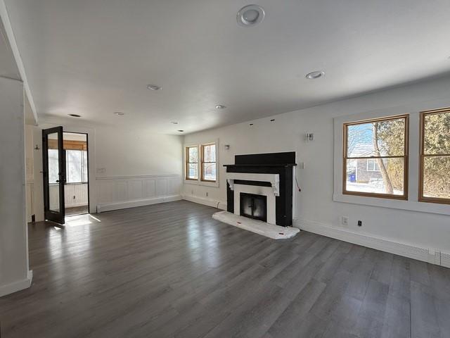 unfurnished living room with dark hardwood / wood-style flooring