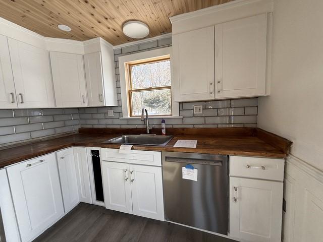 kitchen with sink, dishwasher, white cabinets, wood counters, and wooden ceiling