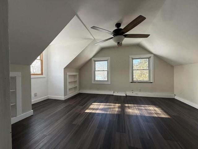 bonus room featuring ceiling fan, lofted ceiling, dark hardwood / wood-style floors, and built in features